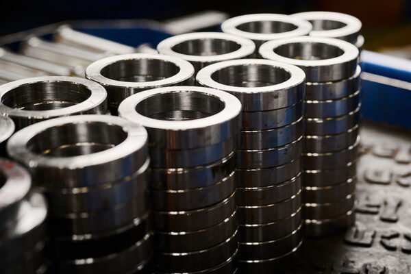 Glare stainless rings made with automatic machine tools closeup. Metalwork plant products. Metal details on display